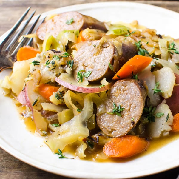 Irish Banger Skillet with sliced sausages braised cabbage potatoes and carrots.
