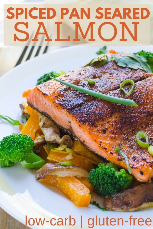 Looking for a healthy Asian salmon recipe? This Spiced Pan Seared Salmon with stir fried veggies and Asian-style sauce is the BEST pan fried salmon recipe. #salmonrecipes #salmonrecipeshealthy #asiansalmon