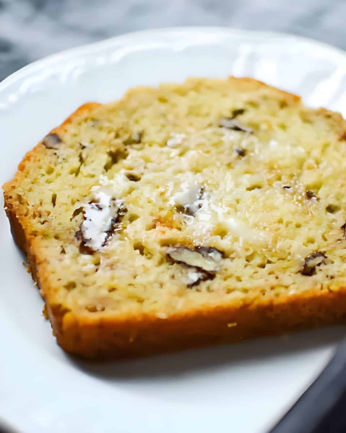 A slice of green chile bread with butter.