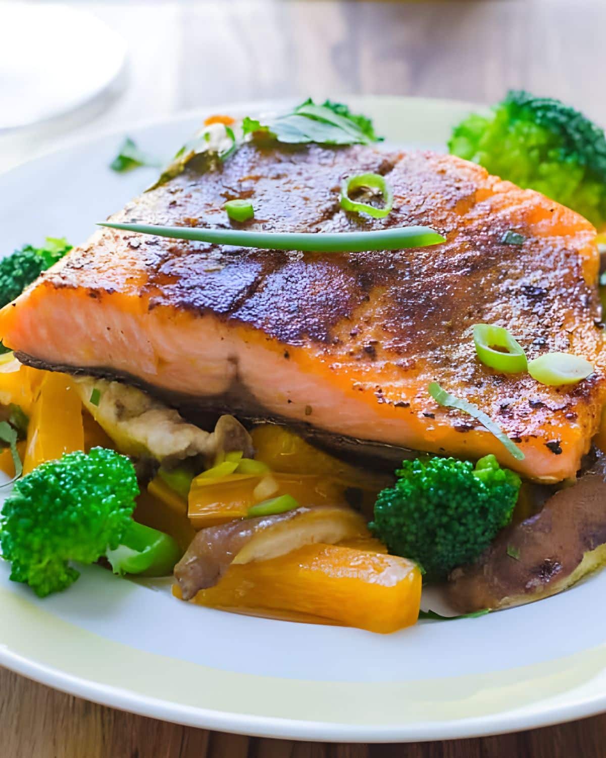 Spiced pan seared salmon over vegetables.