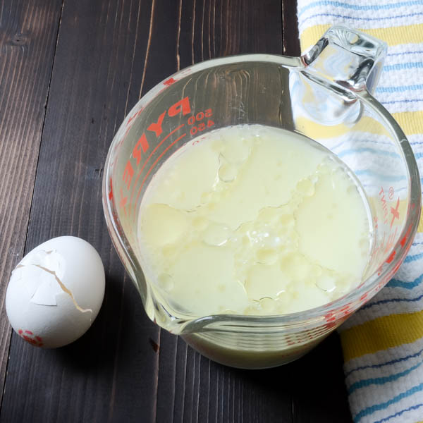 mixing eggs, oil and milk for the hatch green chili bread.