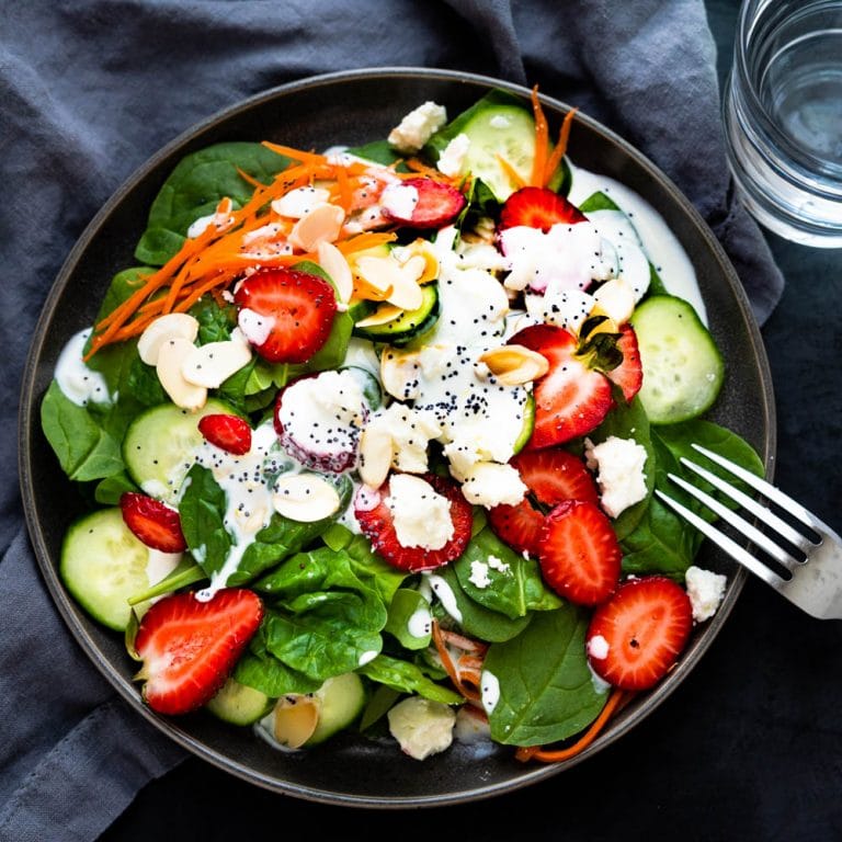spinach strawberry salad on a plate.