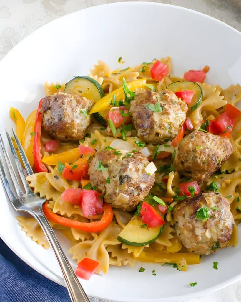 Cajun pasta with meatballs in a bowl.