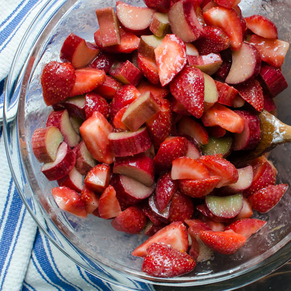 Mixing strawberries and rhubarb with sugar