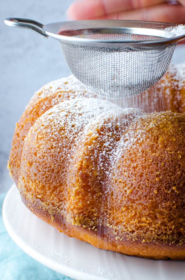 Dusting passion fruit cake recipe with powdered sugar.