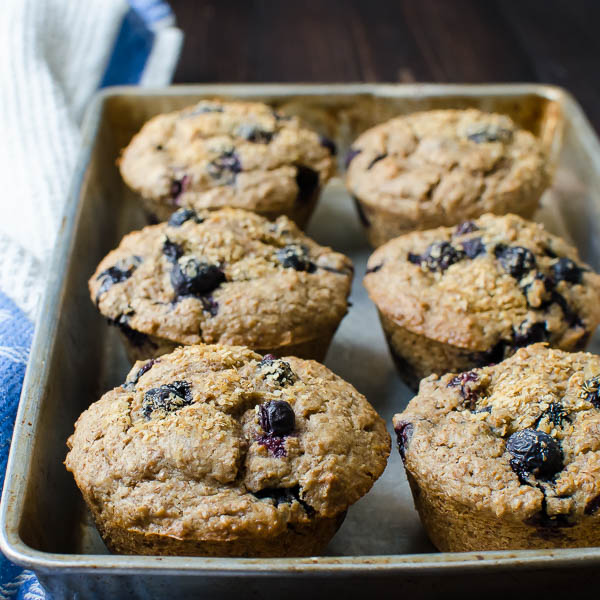 cinnamon blueberry bran muffins on a tray.