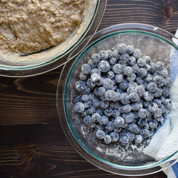 coating blueberries with flour.