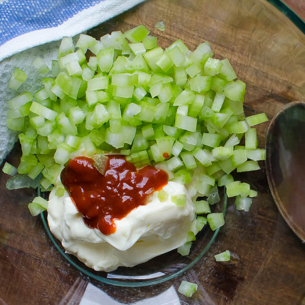 mayonnaise celery and Sriracha sauce in a bowl