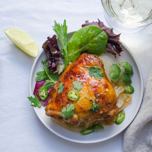 Juicy Asian-Style Chicken Thighs with salad and lime.