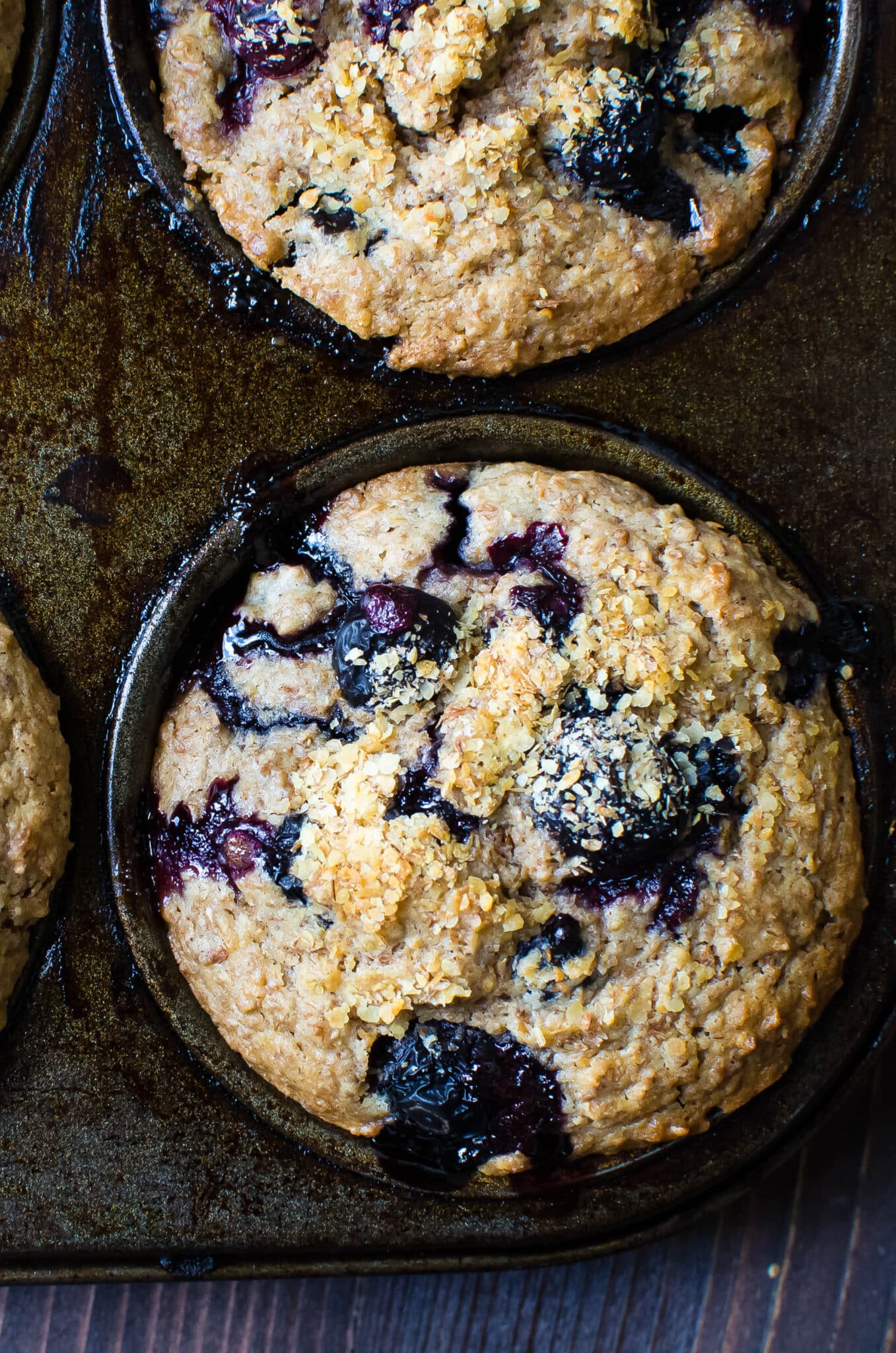 A muffin tin full of blueberry bran muffins.