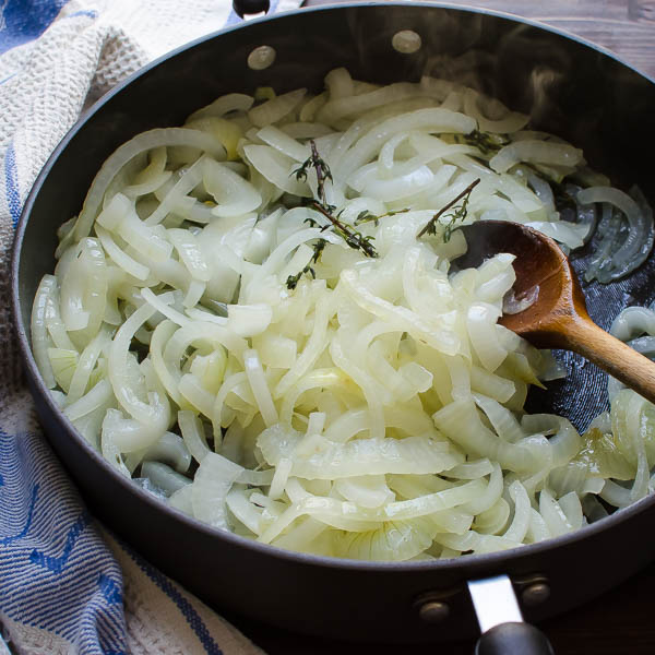 softened onions and wooden spoon