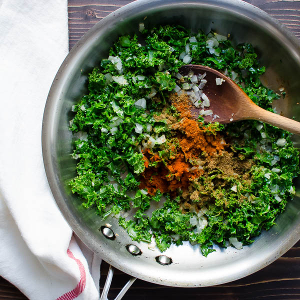 kale and spices in a skillet