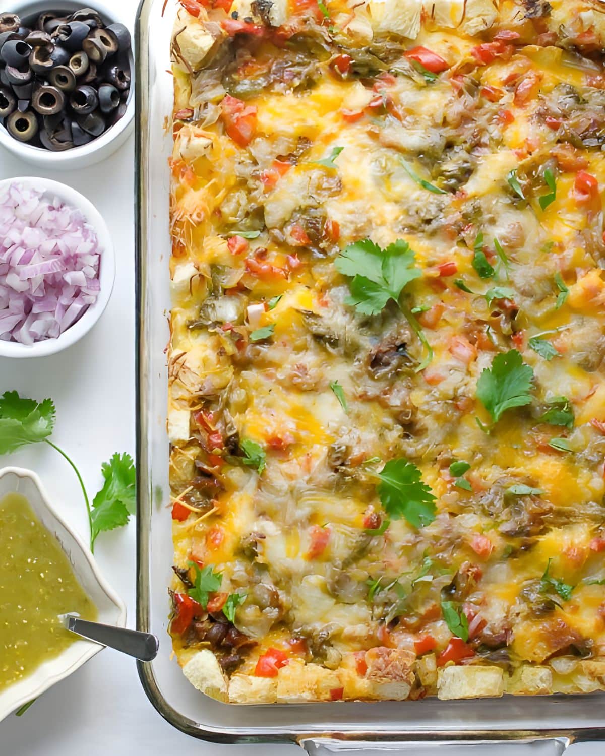 A breakfast strata with hatch chiles and toppings.