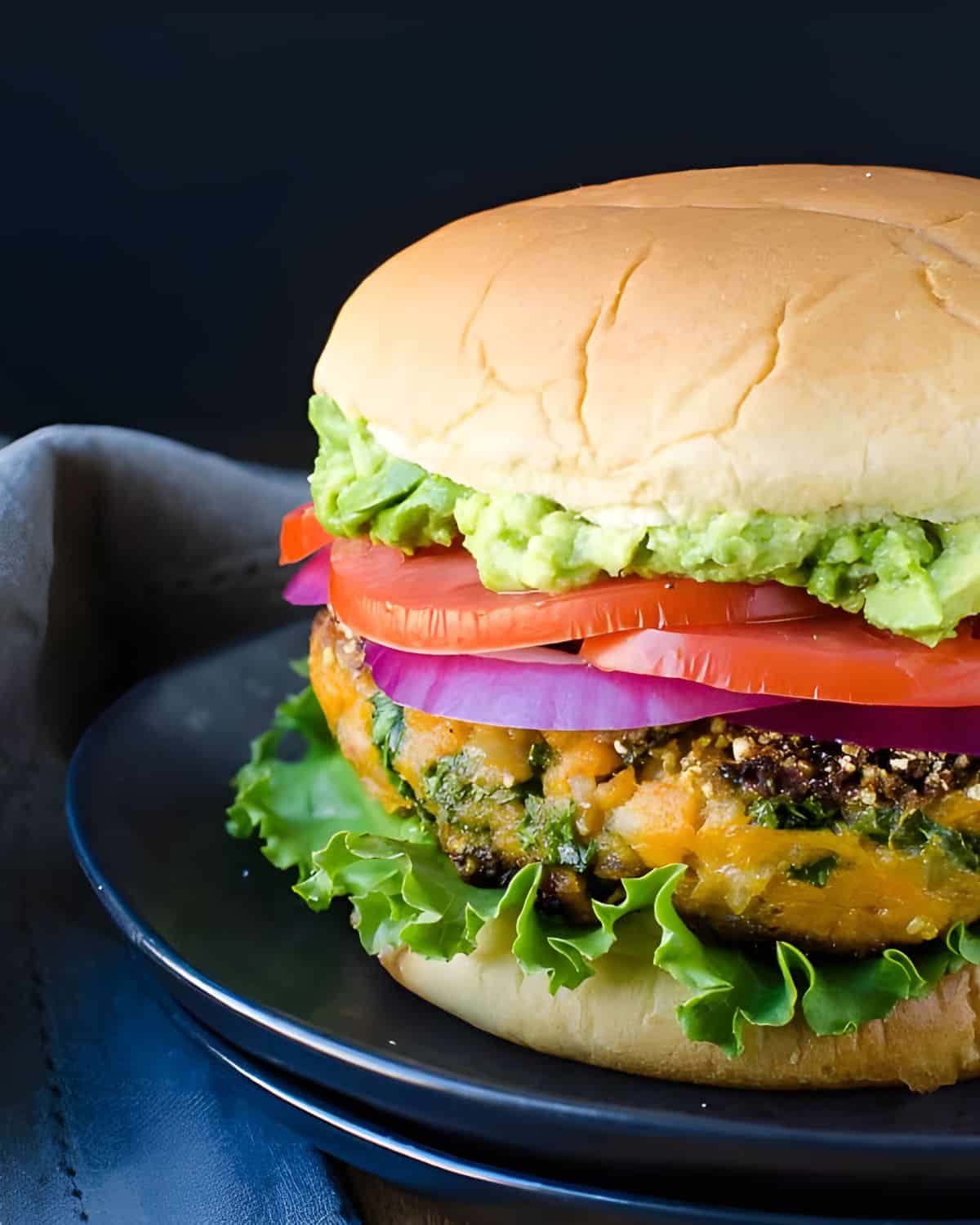 A veggie burger on a bun with toppings.