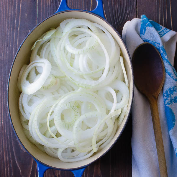 Sliced onions in a dutch oven.