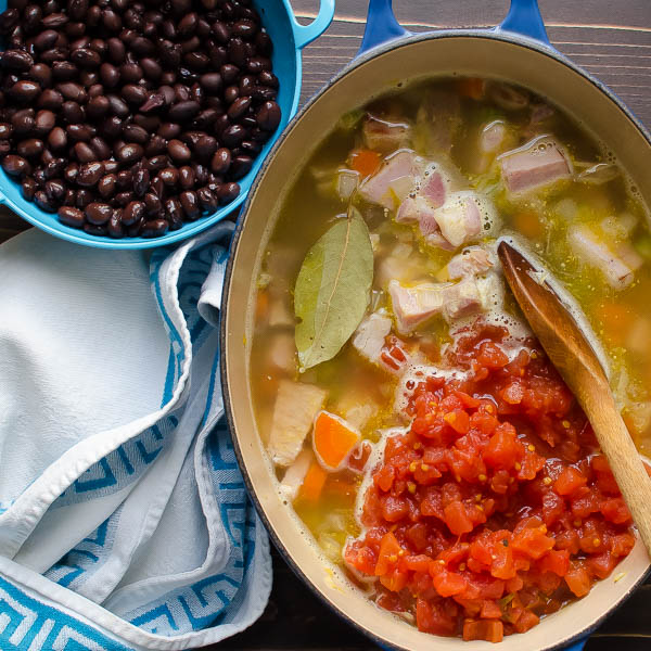 adding tomatoes and beans