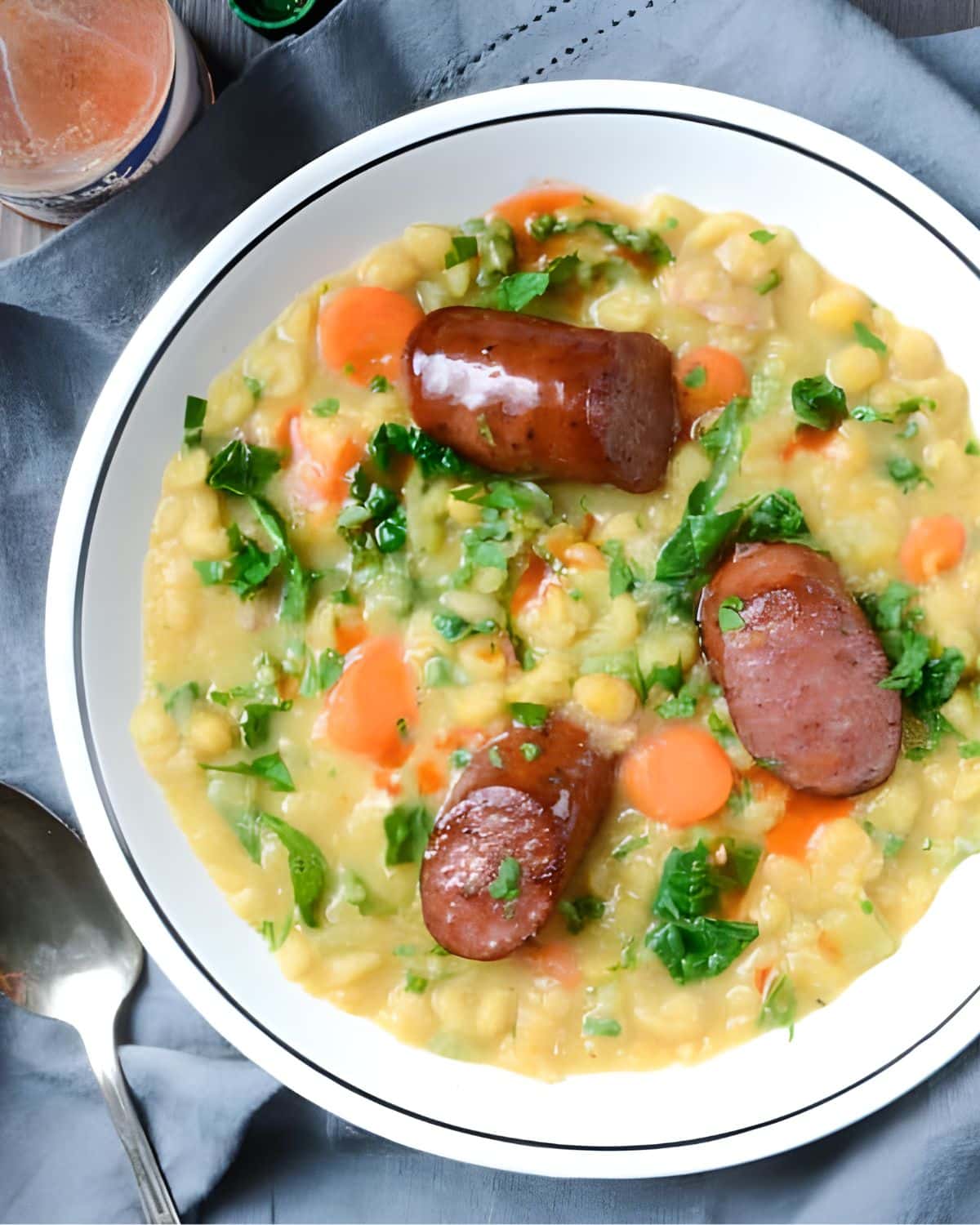 Yellow peas and smoked sausage in a bowl.