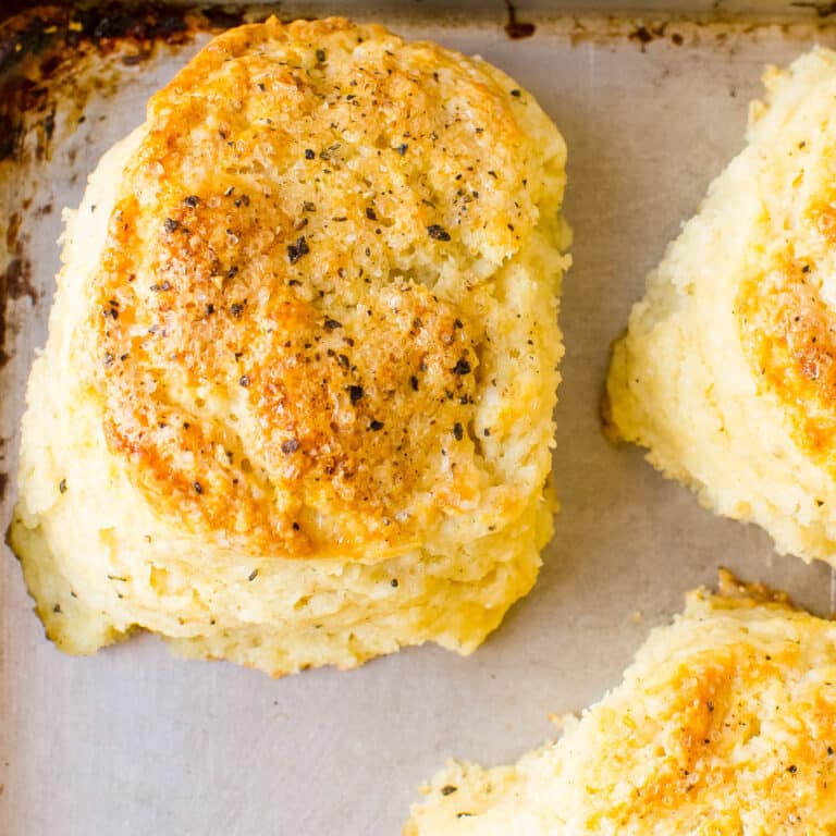 Parmesan biscuits on a baking sheet.