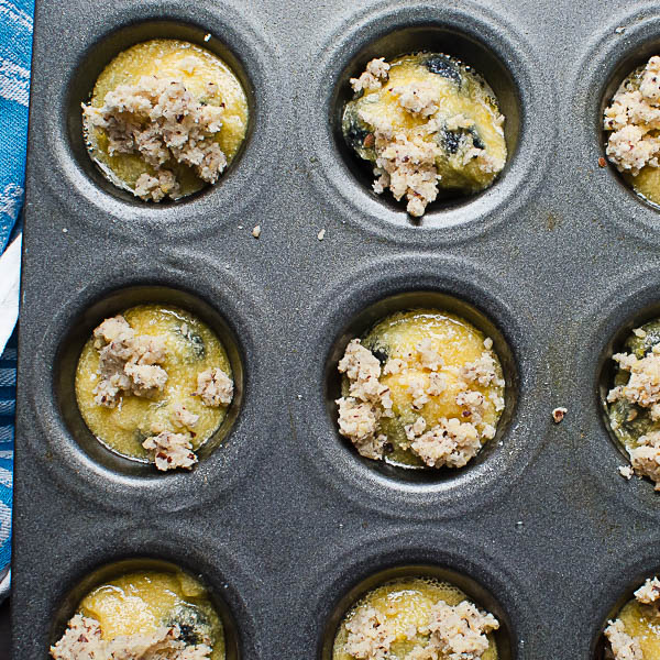 scooping batter into tins for Gluten-Free Blueberry Muffins