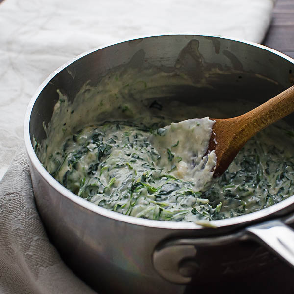 spinach dip and wooden spoon
