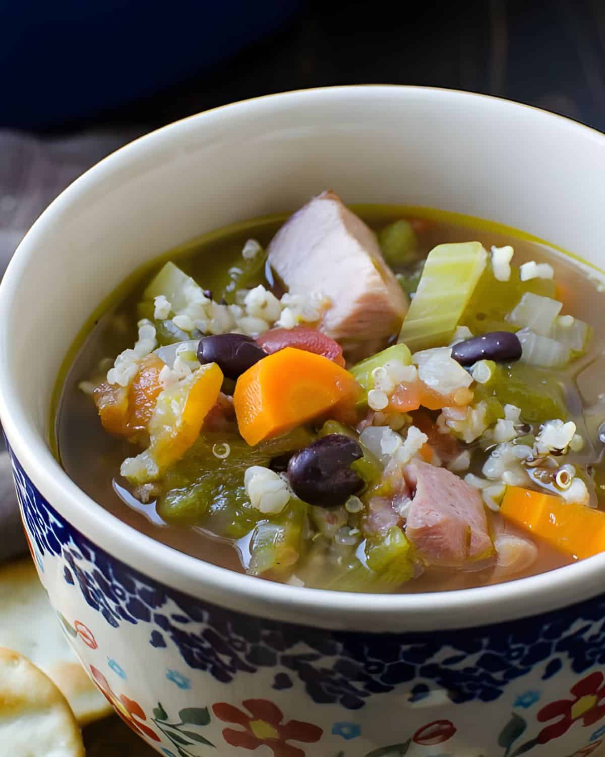 The ham soup with whole grains and black beans in a cup.