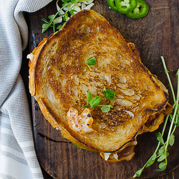 Crispy Pancetta Guava Grilled Cheese on cutting board