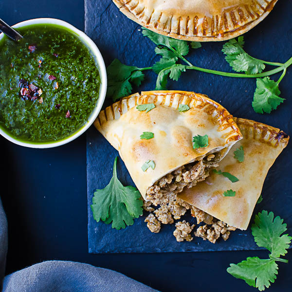 cut empanada with salsa verde