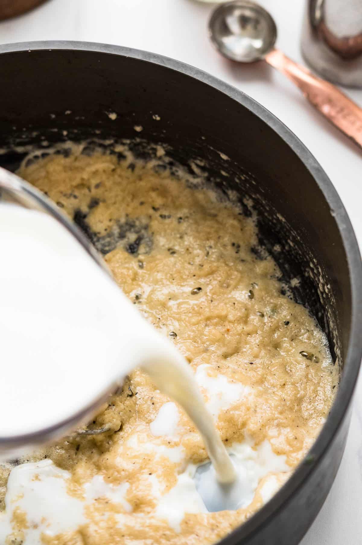 adding milk to the roux makes a creamy sauce for spinach artichoke dip recipe.