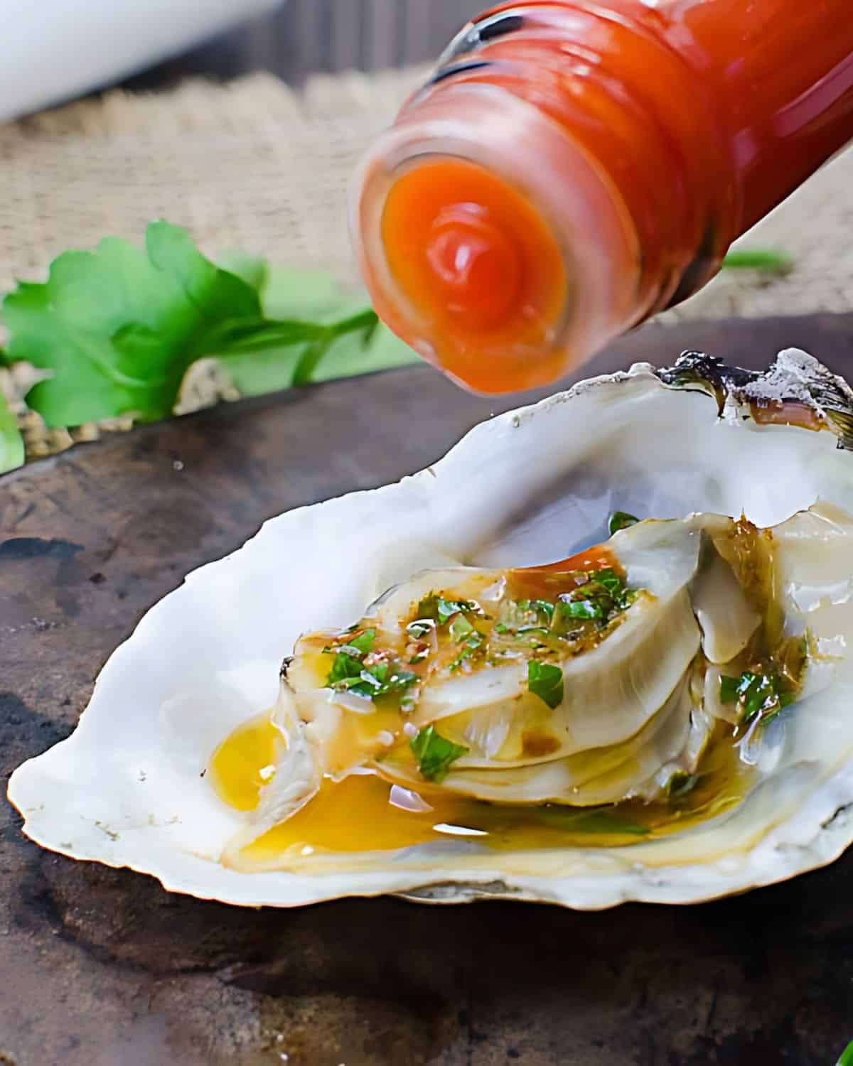 Mardi Gras grilled oysters with hot sauce.