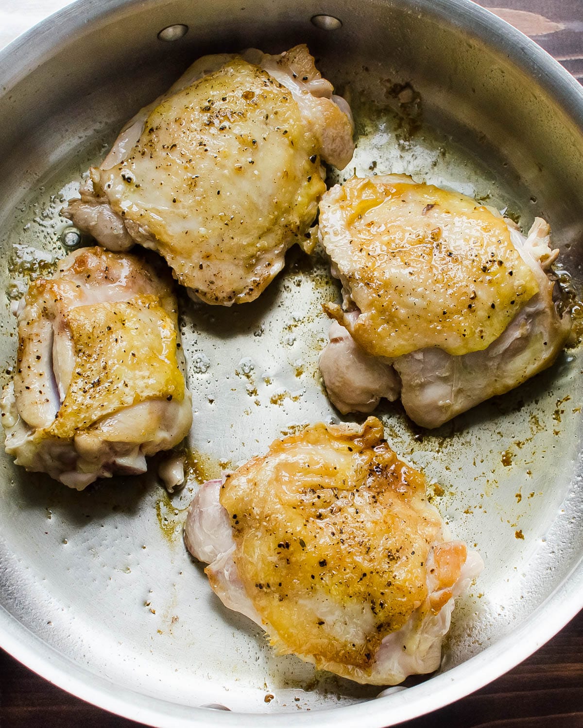 Searing the chicken in a hot skillet.