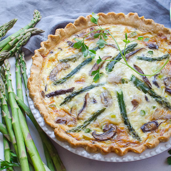 Serving the asparagus and wild mushroom quiche.