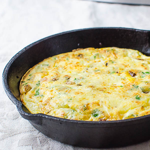 Fluffy cooked frittata in a cast iron skillet.
