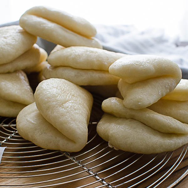 Asian Steamed Buns cooling on a rack.
