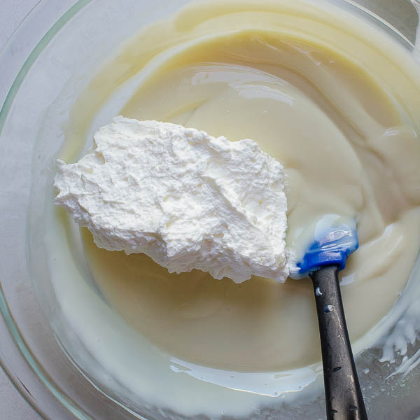 adding whipped cream to key lime filling