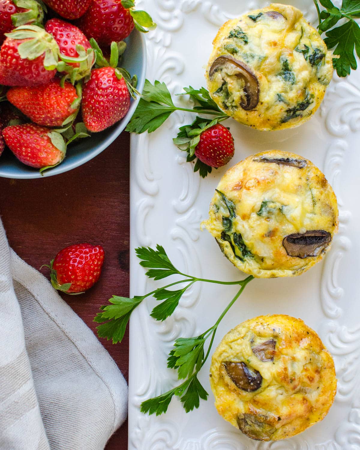 Serving the mushroom and spinach egg bakes on a platter.