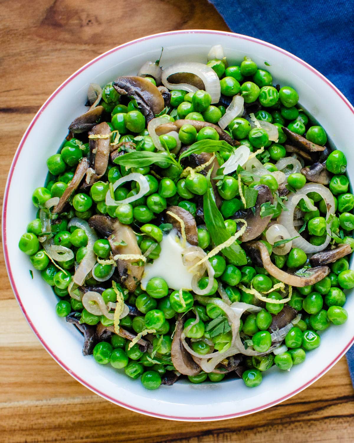 A peas side dish with shallots and mushrooms.