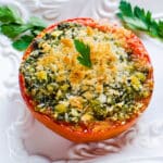 Serving pesto roasted tomatoes on a platter.