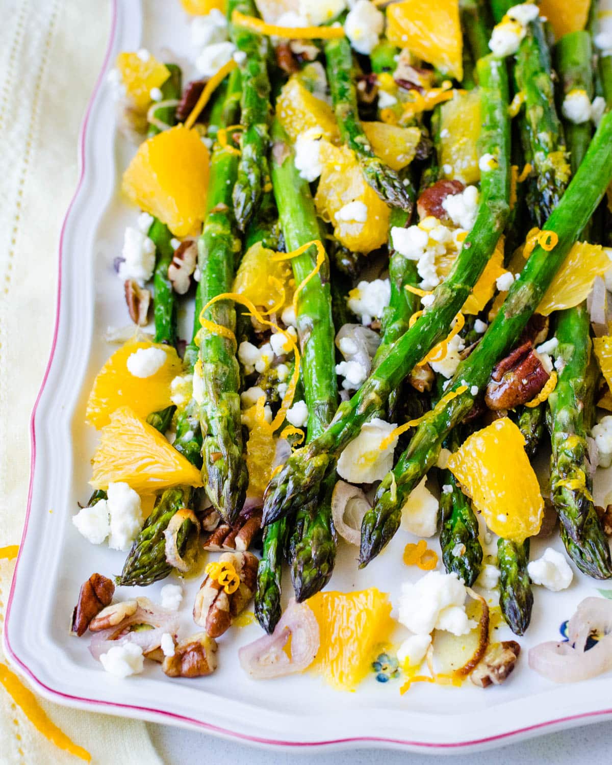 A platter of roasted baby asparagus with citrus.