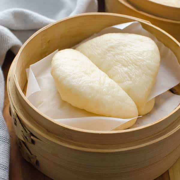 Asian Steamed Buns in a bamboo steamer.