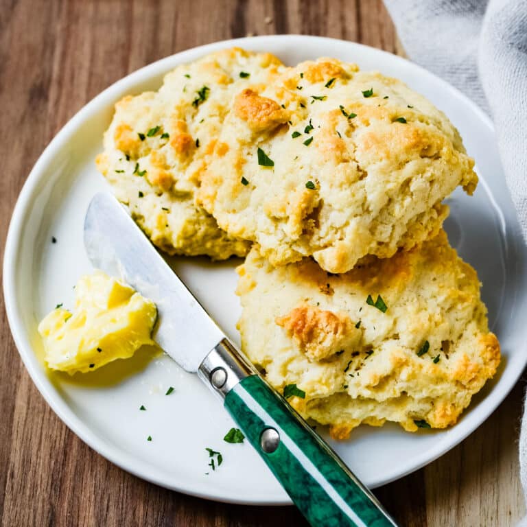 Drop biscuits on a plate with butter.