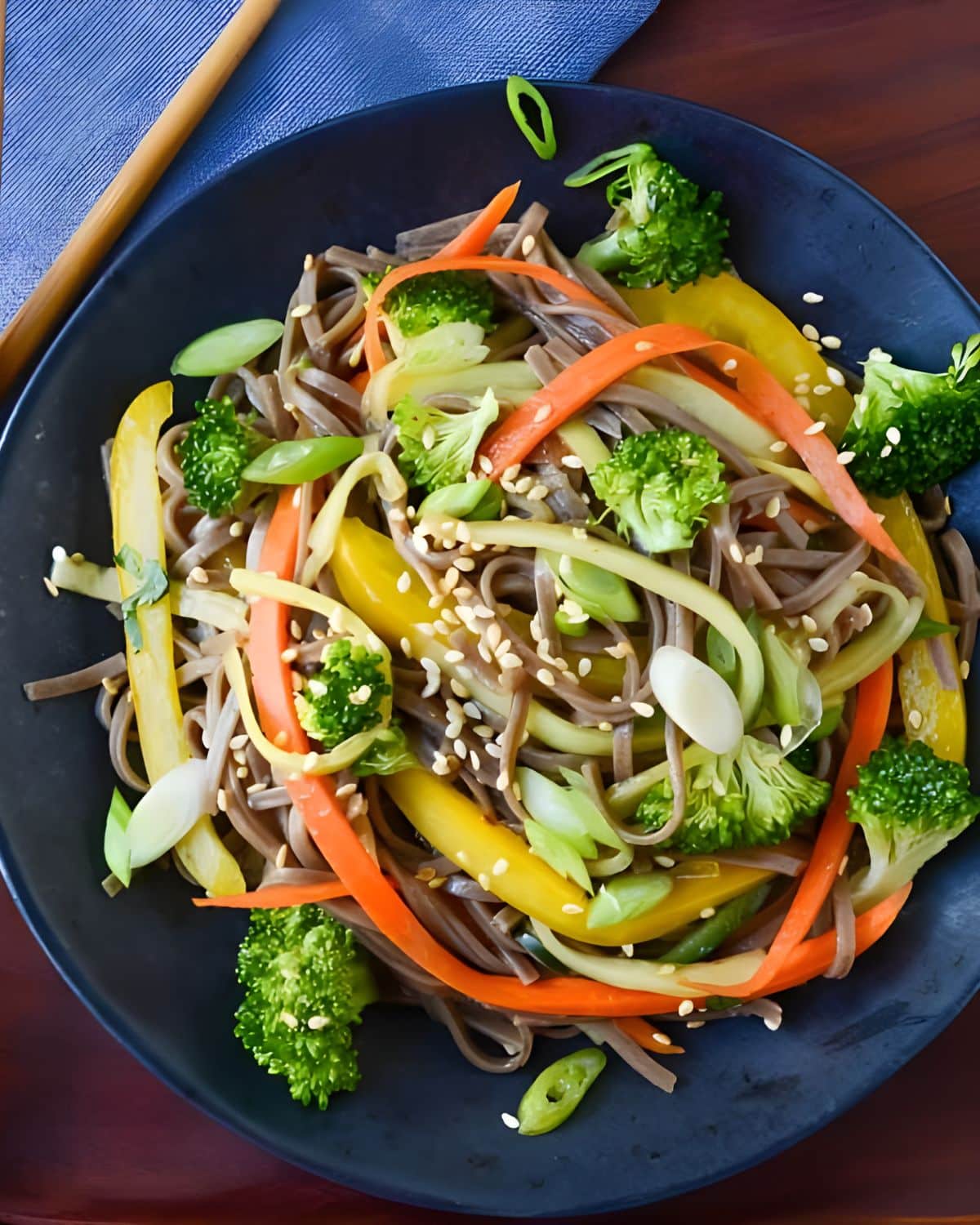 Cold soba noodle salad with fresh veggies and sesame seeds.