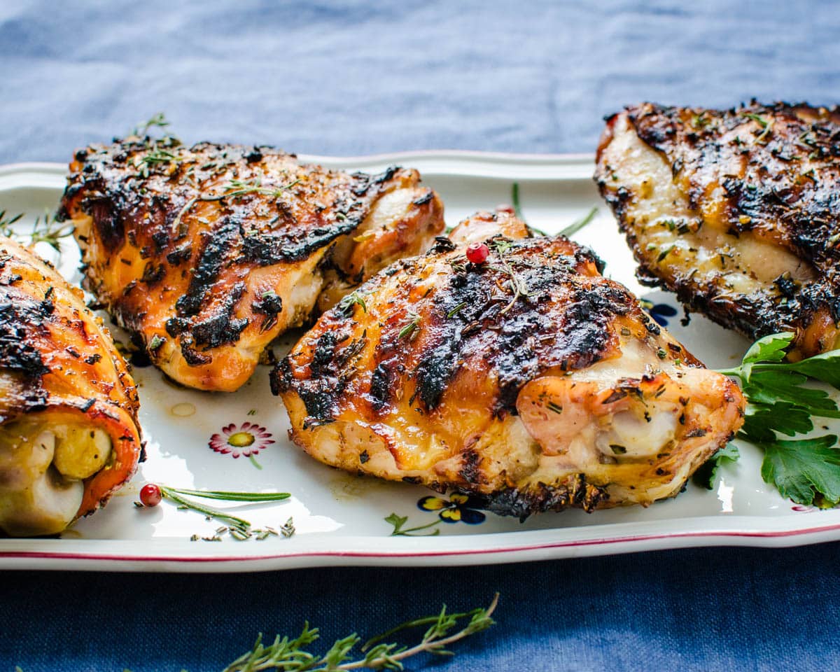 Grilled chicken thighs on a platter.