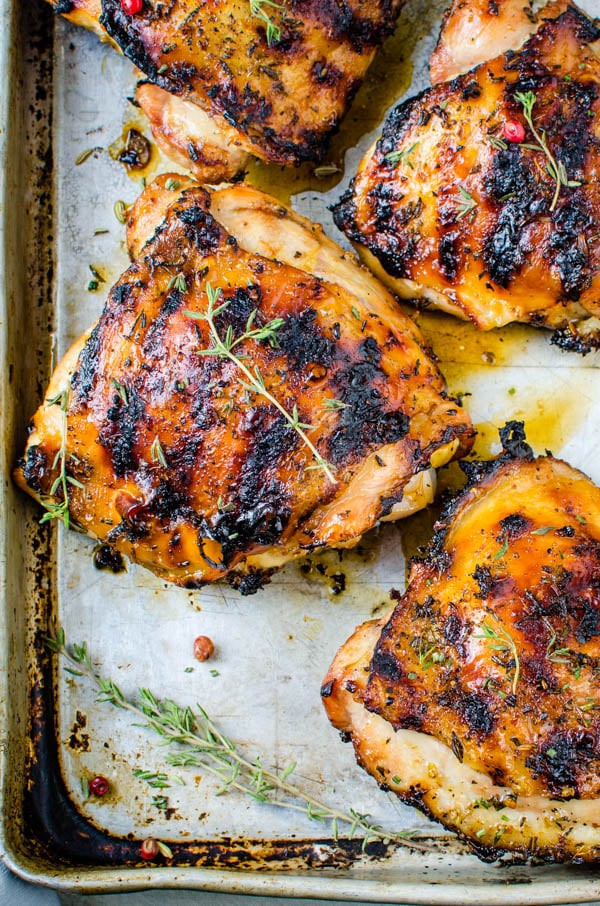 Grilled chicken thighs with chicken rub recipe resting on a sheet pan.