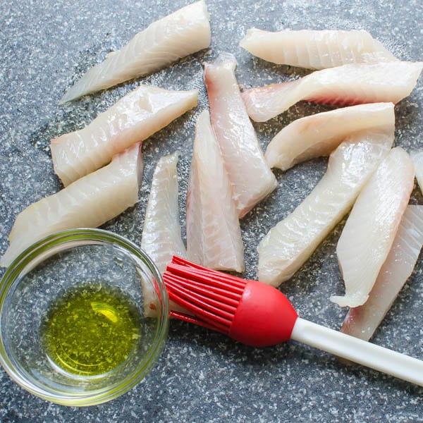 brushing tilapia with olive oil