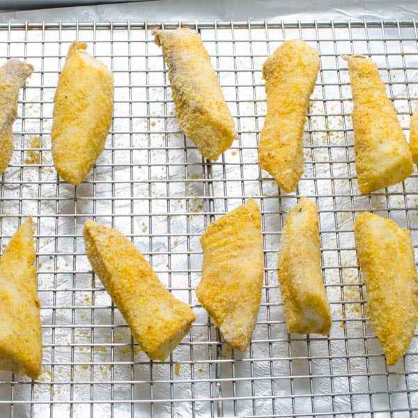 cooked fish fingers on a wire rack.
