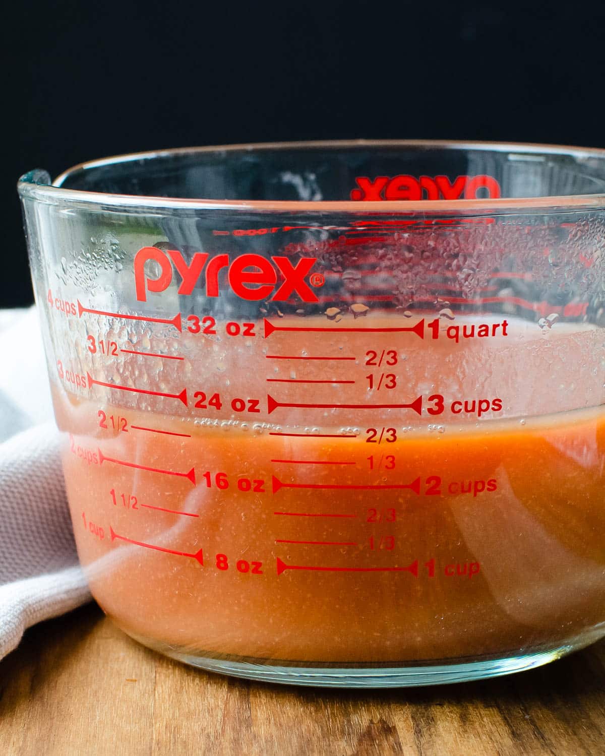 guava puree in a measuring cup.