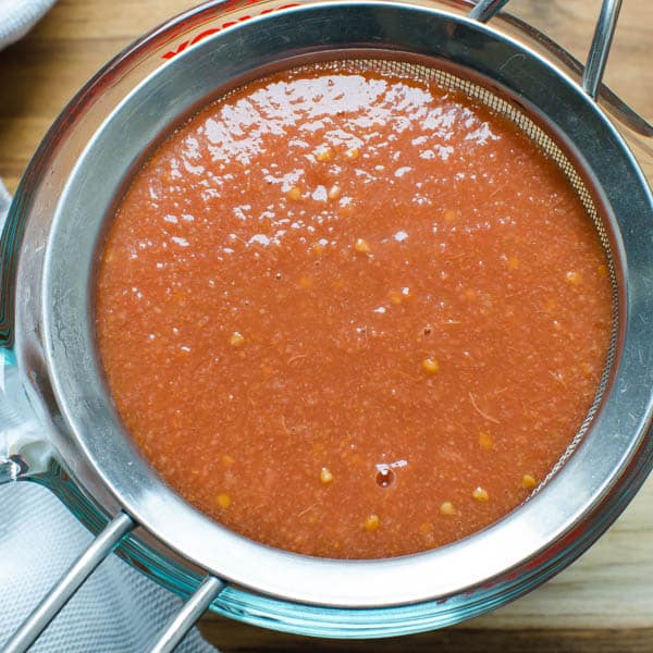 guava puree in a strainer.