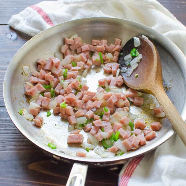 ham and veg in pan with spoon