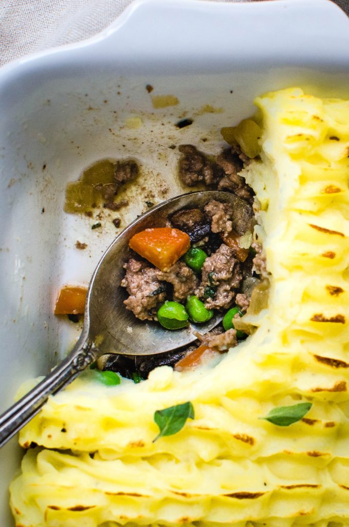 Spooning out shepherd's pie with beef.