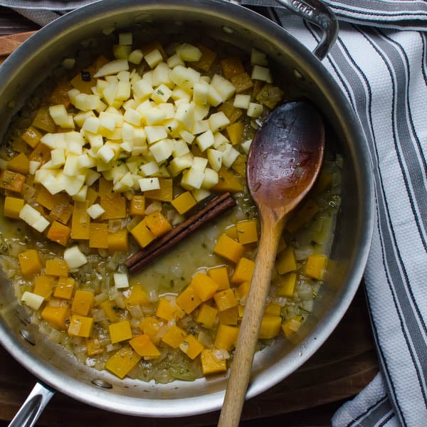 apples, squash and cinnamon in a pan with spoon